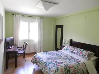 Cama o camas de una habitación en Hostal Rural los Alisos
