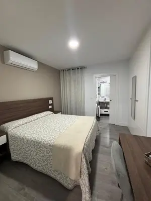 Cama o camas de una habitación en Hostal Los Rosales