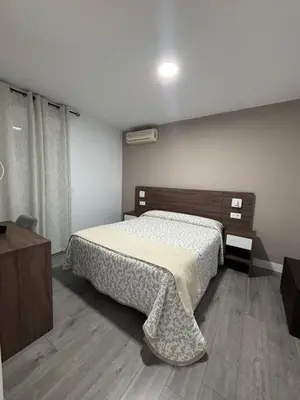 Cama o camas de una habitación en Hostal Los Rosales
