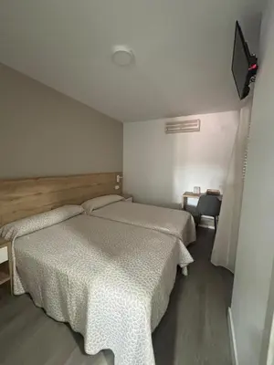 Cama o camas de una habitación en Hostal Los Rosales