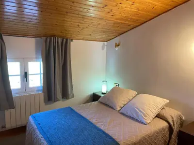 Cama o camas de una habitación en Apartamentos Pico Almanzor