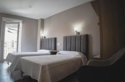 Cama o camas de una habitación en Apartamentos Turísticos Capitán Orellana
