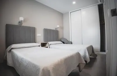 Cama o camas de una habitación en Apartamentos Turísticos Capitán Orellana