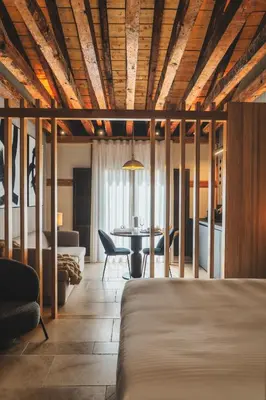 Cama o camas de una habitación en LOS MERCADERES Balneum Suites