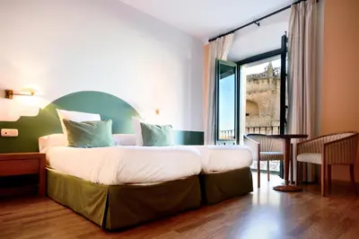 Cama o camas de una habitación en Hotel Ahc Palacio Coria