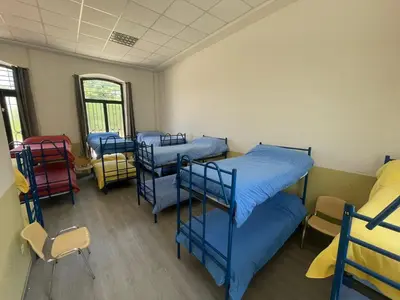 Cama o camas de una habitación en El Vagón Bar-Albergue Béjar