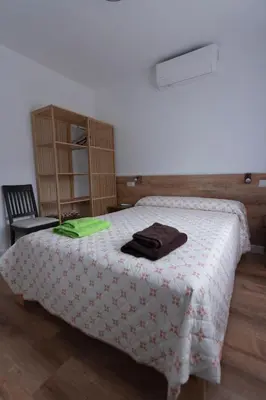 Cama o camas de una habitación en El Salón de Arriba