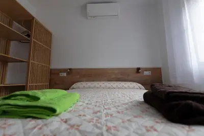 Cama o camas de una habitación en El Salón de Arriba