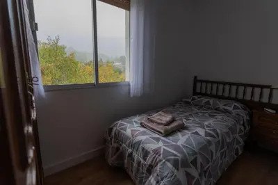 Cama o camas de una habitación en El Salón de Arriba