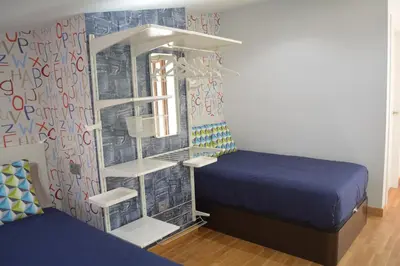 Cama o camas de una habitación en Apartamento Turístico Casa Museo Parking y Cargador