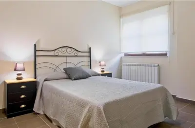 Cama o camas de una habitación en Apartamentos turísticos Sardon
