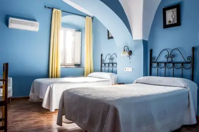 Cama o camas de una habitación en Hostal San Miguel