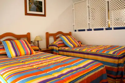Cama o camas de una habitación en Hotel Apartamentos Kantara Al-Saif