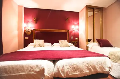 Cama o camas de una habitación en Hostal Goya Suites