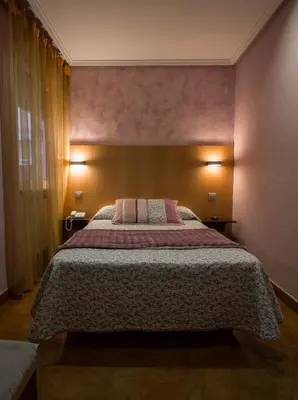 Cama o camas de una habitación en Hostal Goya Suites