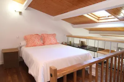 Cama o camas de una habitación en PINTORES ROOMS Apartamentos Turísticos