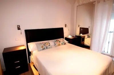 Cama o camas de una habitación en PINTORES ROOMS Apartamentos Turísticos