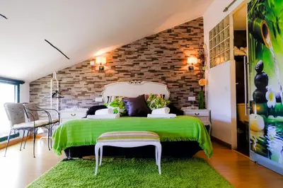 Cama o camas de una habitación en Atico Romántico