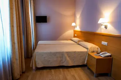 Cama o camas de una habitación en Hotel Castilla