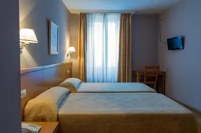 Cama o camas de una habitación en Hotel Castilla