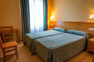 Cama o camas de una habitación en Hotel Castilla