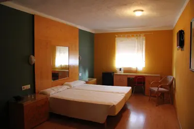 Cama o camas de una habitación en AHC Hoteles