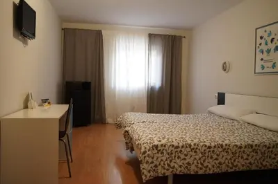 Cama o camas de una habitación en AHC Hoteles