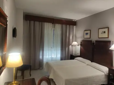 Cama o camas de una habitación en Hotel Iberia Plaza América