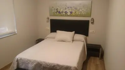 Cama o camas de una habitación en Apartamentos Mitreo