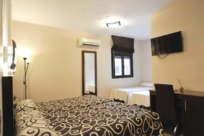 Cama o camas de una habitación en Hotel Ciudad de Plasencia