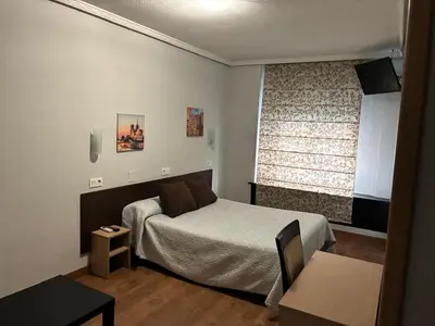 Cama o camas de una habitación en Hostal Conde David