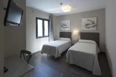 Cama o camas de una habitación en Hostal Emeritae