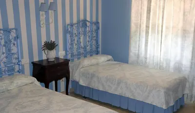 Cama o camas de una habitación en Hostal Emilia