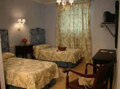 Cama o camas de una habitación en Hostal Emilia