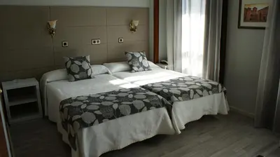 Cama o camas de una habitación en Hotel Los Naranjos