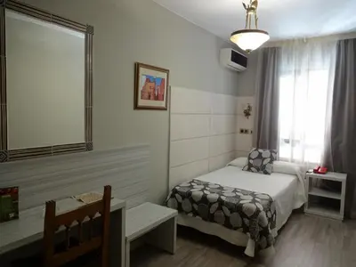 Cama o camas de una habitación en Hotel Los Naranjos