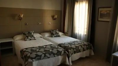 Cama o camas de una habitación en Hotel Los Naranjos