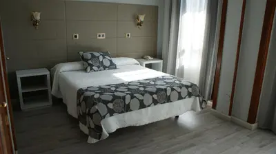 Cama o camas de una habitación en Hotel Los Naranjos