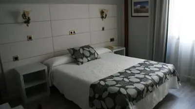 Cama o camas de una habitación en Hotel Los Naranjos