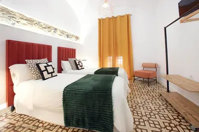 Cama o camas de una habitación en Apartamentos Durán Pizarro 1930