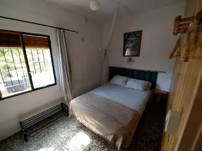 Cama o camas de una habitación en La Tierra Verde COTTAGE