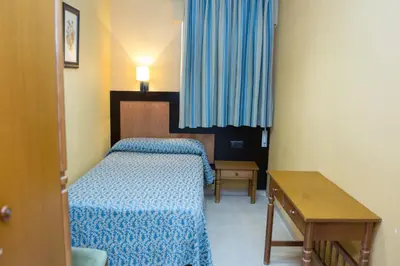 Cama o camas de una habitación en Hostal La Palmera