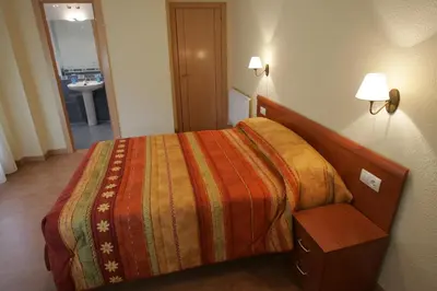 Cama o camas de una habitación en Hostal Hispanico II