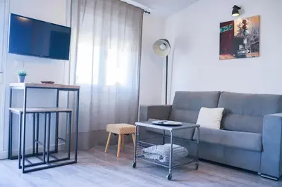 Una televisión o centro de entretenimiento en Apartamentos Suites Cariátide