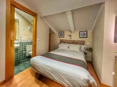 Cama o camas de una habitación en Hostal la Colmena