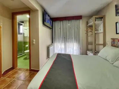 Cama o camas de una habitación en Hostal la Colmena
