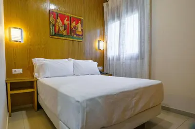 Cama o camas de una habitación en Hostal Acueducto Los Milagros