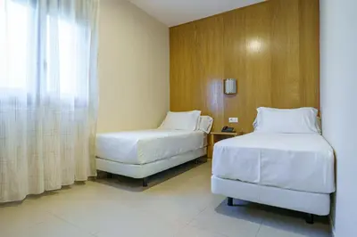 Cama o camas de una habitación en Hostal Acueducto Los Milagros