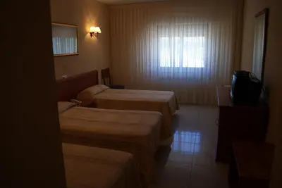 Cama o camas de una habitación en Hotel Alameda