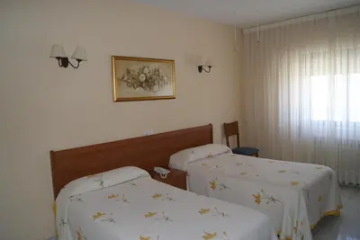 Cama o camas de una habitación en Hotel Alameda